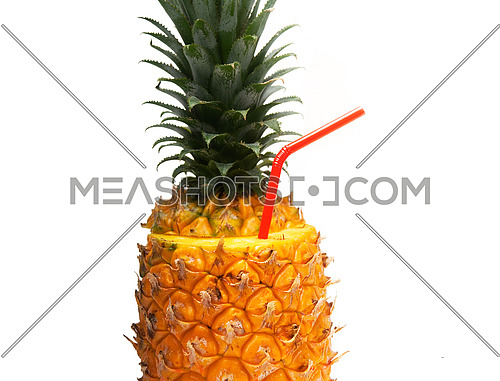 ripe pineapple cutted on top with red straw