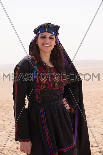 egyptian woman in traditional clothes in front of ancient giza pyramids