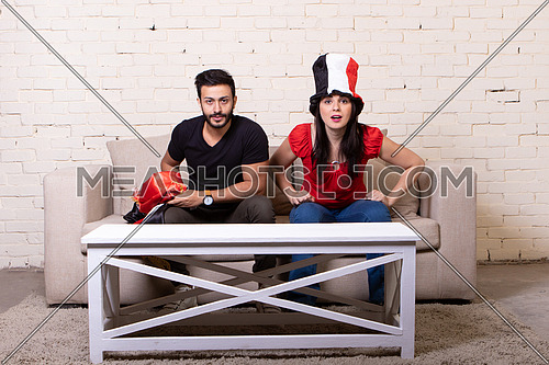 couple sitting on a couch at home