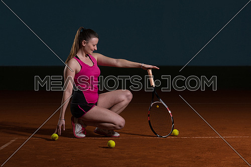 Portrait Of Woman Tennis Player With Racket Ready To Hit A Tennis Ball