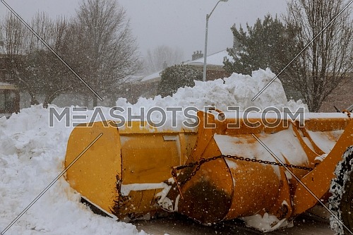 shnekorotor removes snow on the road in the village after heavy snowfall.