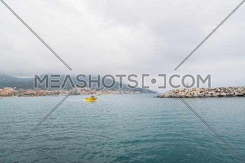 Yellow fishing boat while returning to the port of Varazze, Liguria,Italy.