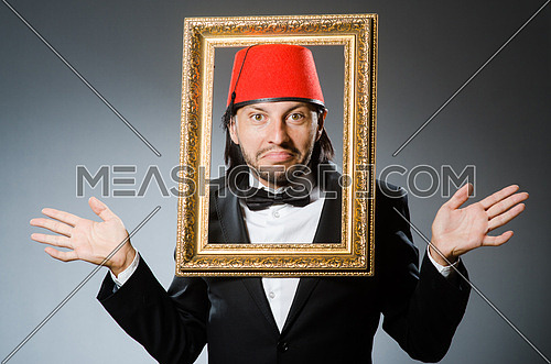 Man with fez  hat and picture frame