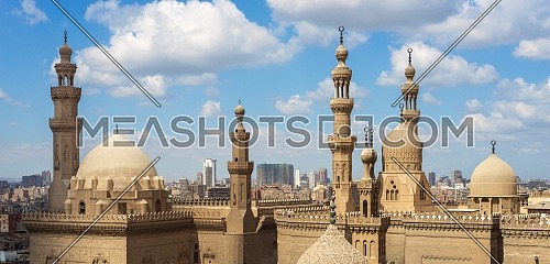 Aerial day shot of minarets and domes of Sultan Hasan mosque and Al Rifai Mosque in cloudy day, Old Cairo, Egypt