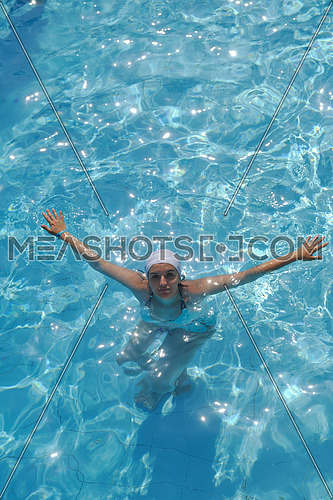 happy young woman relax at swimming pool at vacation travel resort 