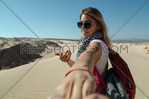 Follow me shot with blond female tourist
