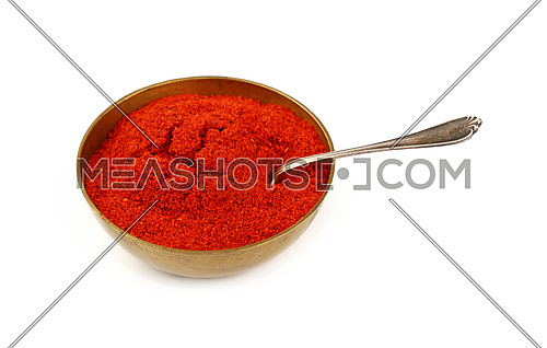 Close up one bronze metal bowl full of red chili pepper or paprika powder with spoon isolated on white background, high angle view