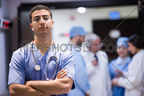 portrait of middle eastern team of doctors in a large modern clinic, one in front of the other