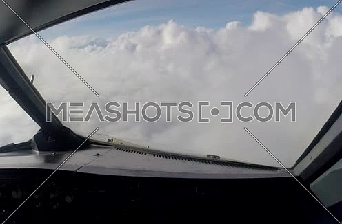 inside cockpit shot for plane flying through clouds 