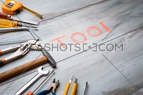 Set of work tool on rustic wooden background with written 