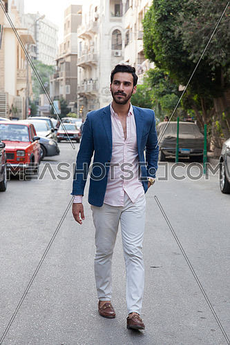 A young business man walking in the street