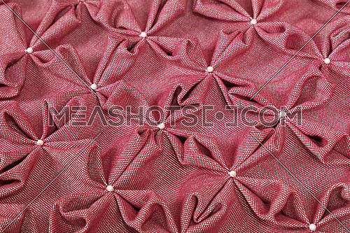 Close up background texture of pink textile puffs for Canadian smocking upholstery decoration with beads
