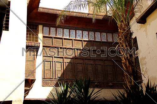 a photo from an ancient house in Islamic Cairo showing the special architecture used at that time and wooden windows