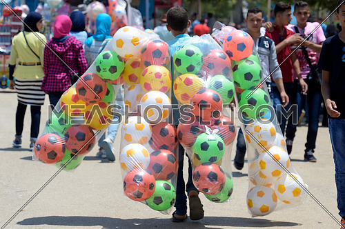 A man carrying colorful balls and selling them to kids during eid al fitr celebrations on july 7 2016