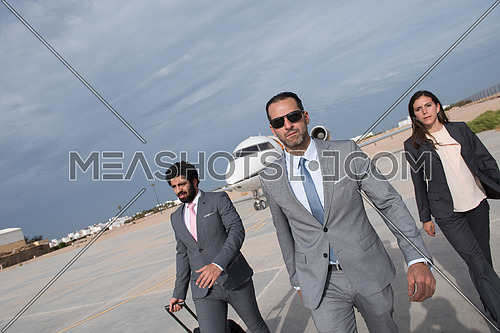 young successful middle eastern businessmen with a suitcase walking in front of private airplane