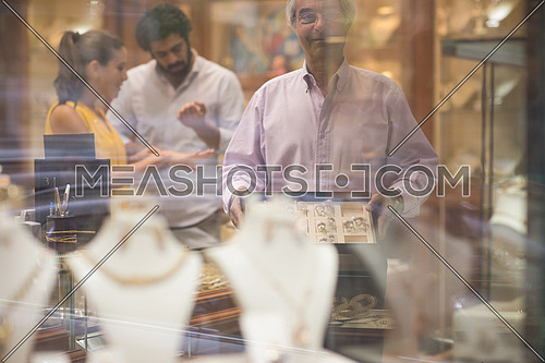 Young middle eastern happy couple enjoying while buying in a luxury jewelry store