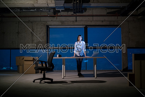portrait of young female architect on construction site checking documents and business workflow using laptop computer in new startup office