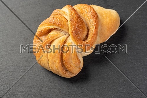sweet, homemade pastry with cinnamon on dark background