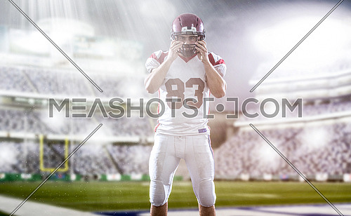 American Football Player isolated on big modern stadium field with lights and flares