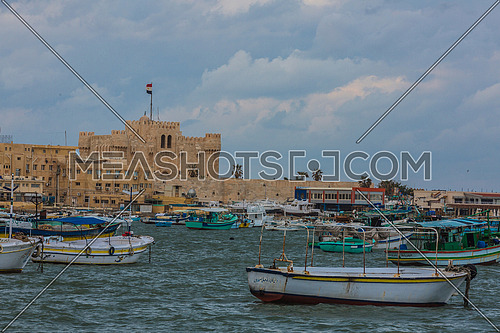 Long Shot outside Citadel of Qaitbay shows fishing boats at day