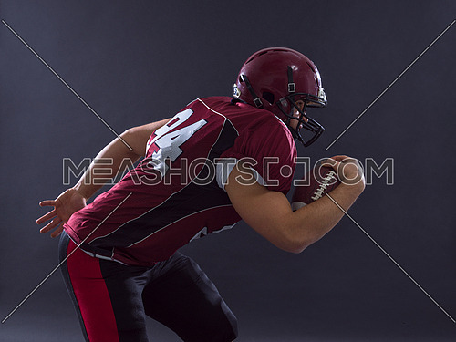 American football Player running with the ball isolated on a gray background