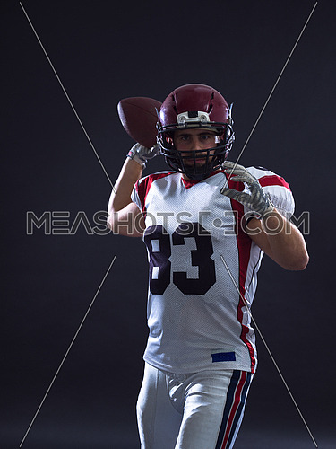 one quarterback american football player throwing ball isolated on gray background