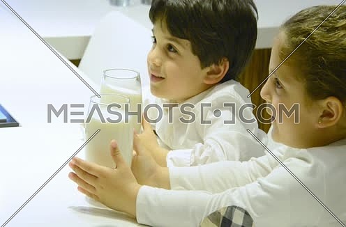 Close up for two kids drinking milk 