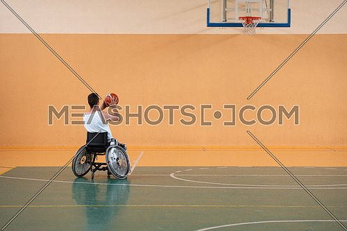 a photo of a war veteran playing basketball with a team in a modern sports arena. The concept of sport for people with disabilities. High quality photo