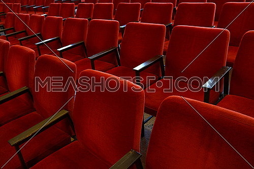 Close up red soft chair seats in a row, personal perspective, high angle view