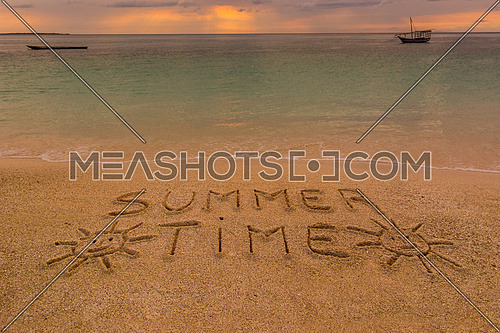 In the picture a beach at sunset with the words on the sand \