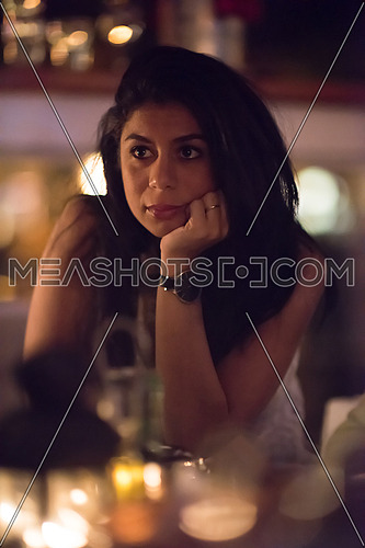 portrait of a young middle eastern beautiful woman who enjoys while sitting