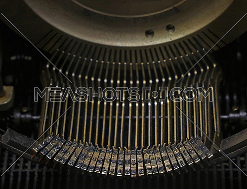 Latinic and Cyrillic typeface of old vintage antique typewriter metal type bar close up, high angle view, personal perspective