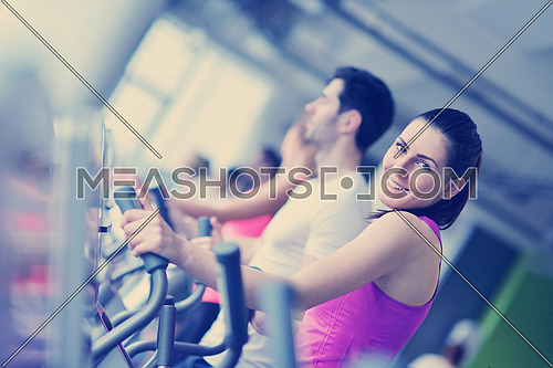 group of young people running on treadmills in modern sport  gym