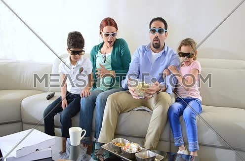 middle eastern family watching 3d content at home livingroom