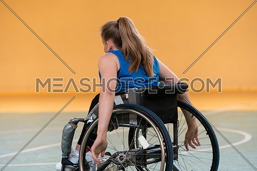 a young woman playing wheelchair basketball in a professional team. Gender equality, the concept of sports with disabilities. High quality photo