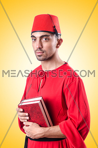 Young turk with book on white