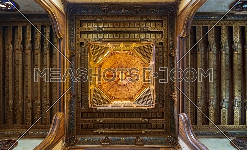 Wooden decorated dome mediating ornate wooden ceiling with floral pattern decorations at Sultan al Ghuri Mausoleum, Cairo, Egypt