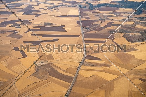 Aerial view of the Madrid region, outside the metropolitan area. Flying over agricultural fields and road. Spain