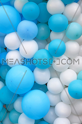 Close up festive background of blue and white air balloons of different sizes