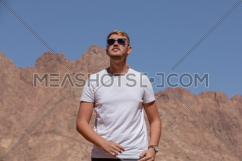 Long shot for a male tourist exploring Sinai Mountain for wadi Freij by day.