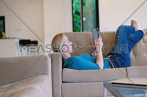 woman using tablet on couch in modern villa home