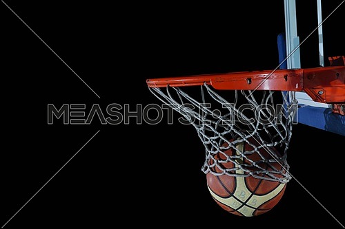 Basketball ball,  board and net  on black background in gym indoor