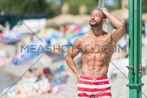 Handsome Man Doing A Shower In A Pool Spa Outdoors
