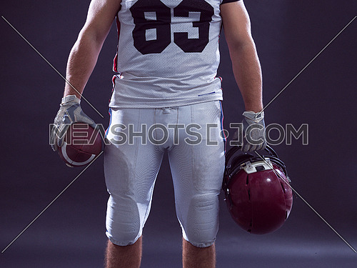 Closeup Portrait of a strong muscular American Football Player isolated on gray