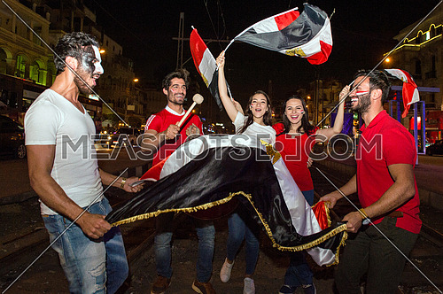 Some young people in the street are encouraging the Egyptian football team and the joy of their arrival at the World Cup in Russia