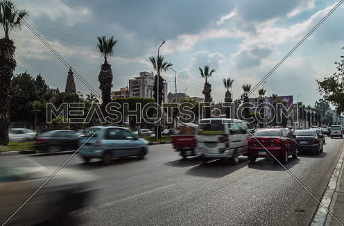 Track Right Shot for traffic at Salah Salim Street showing Le Baron Palace in background at Daytime
