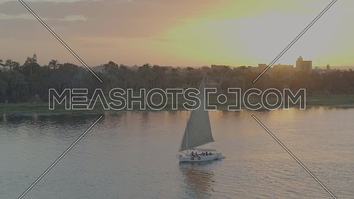 Fly over the River Nile showing a Sailboat at sunset - December 2018.