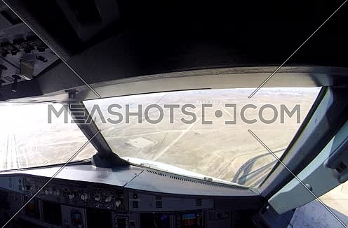 inside cockpit shot  flying toward runway at day