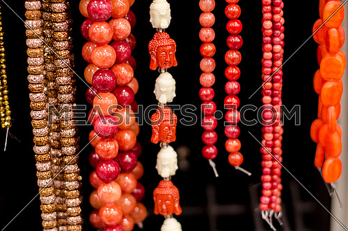 red and white  jewelry stones hanged in a shop