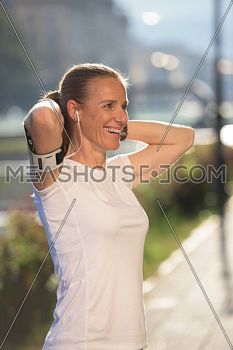 portrait of jogging woman before running  on early morning with sunrise in background